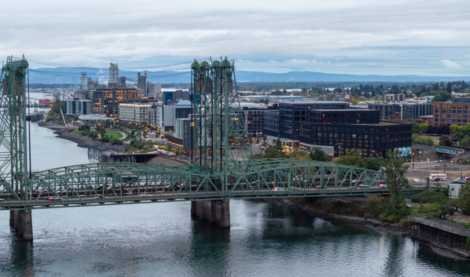 Aerial view of the Columbia River featuring Highway 5 and the Oregon-Washington Bridge, with Terminal 1 mixed-use development site spanning the background along the waterfront.