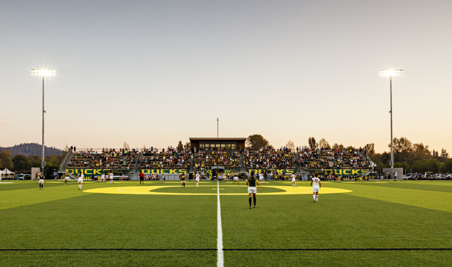Papé Field, for University of Oregon womens soccer and lacrosse, seen from center line during game, bleachers reading Go Ducks
