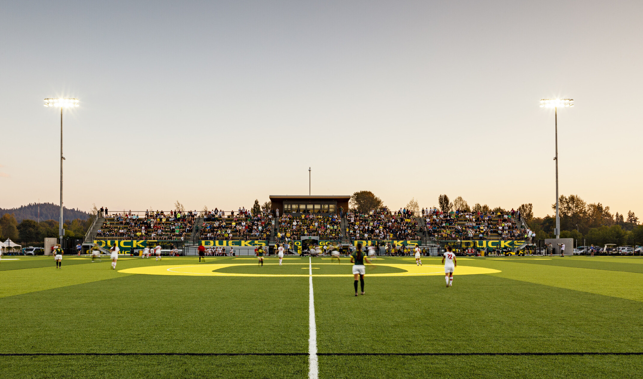 Papé Field, for University of Oregon womens soccer and lacrosse, seen from center line during game, bleachers reading Go Ducks