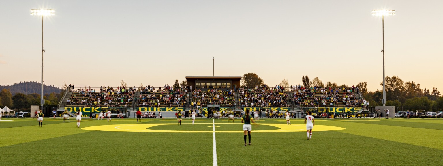 Papé Field, for University of Oregon womens soccer and lacrosse, seen from center line during game, bleachers reading Go Ducks