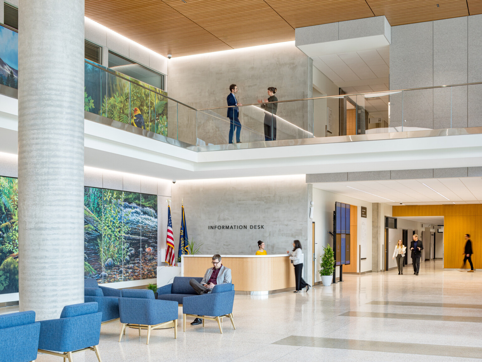 interior lobby of Clackamas County Courthouse; double height space with modern white design; natural and LED lighting; left wall with blue and green mural