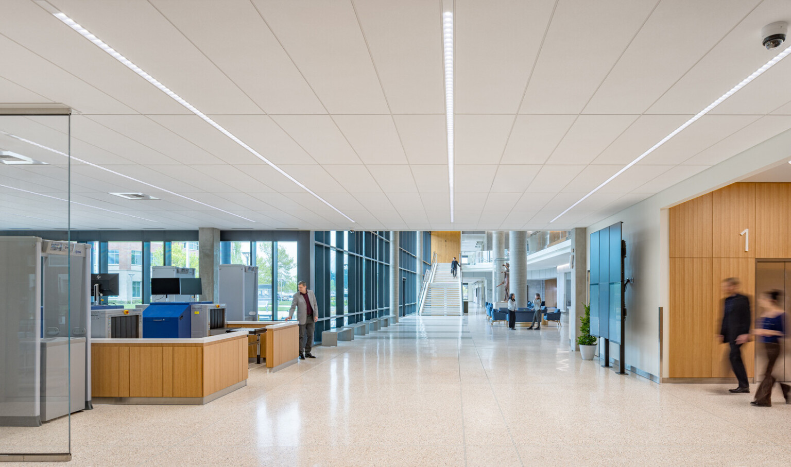 interior of Clackamas County Courthouse; white ceiling and walls; accented by bright timber structures and glass walls