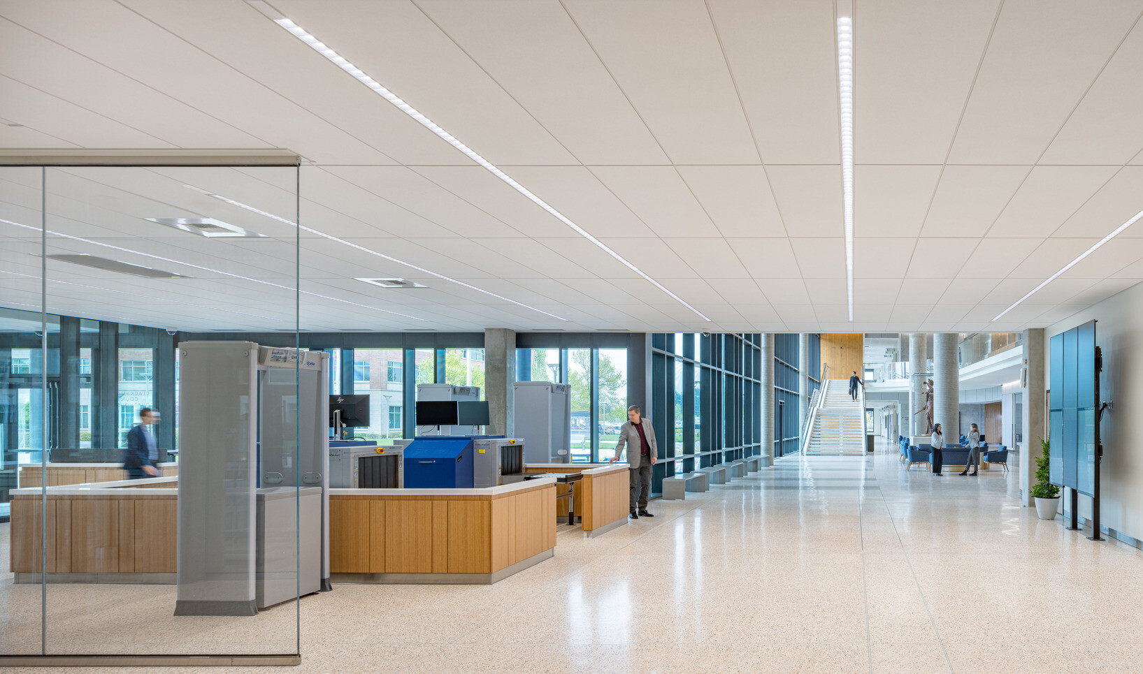 interior of Clackamas County Courthouse; white ceiling and walls; accented by bright timber structures and glass walls
