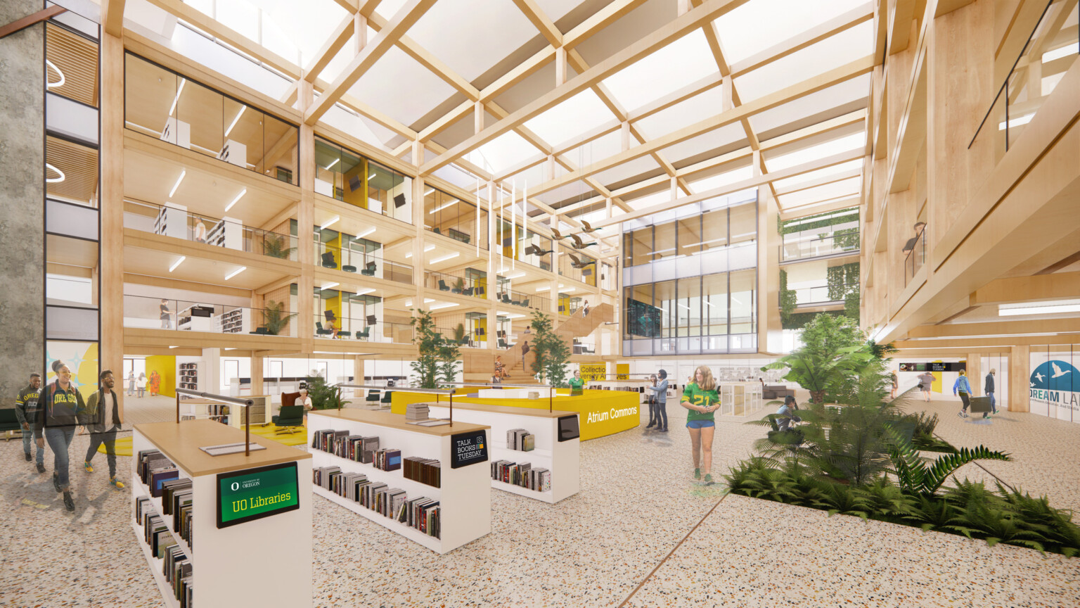 Multistory college library with light wood walls and ceiling beams, white bookshelves, and glass windows