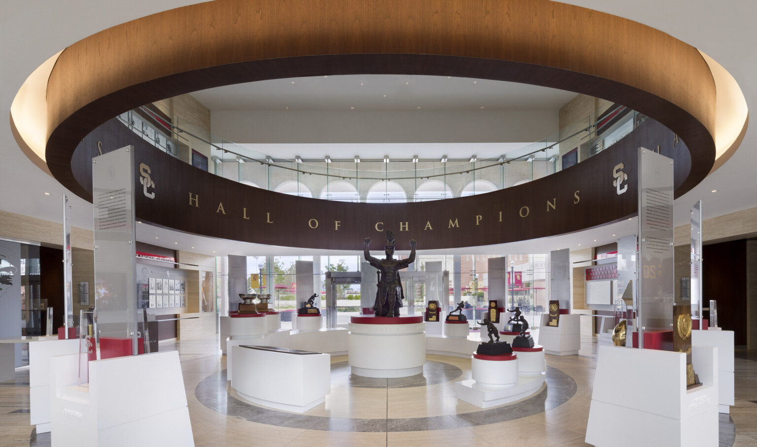 University of Southern California Heritage Hall interior, Spirit of Troy exhibit. Wood circle hangs around display and statue