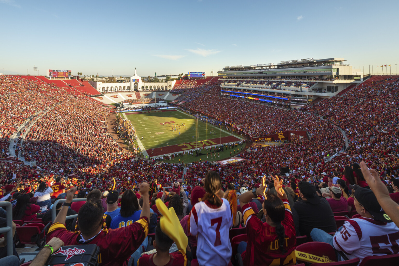 Full stadium of fans in red during dusk football game at the LA Memorial Coliseum Full stadium of fans in red during dusk football game at the LA Memorial Coliseum