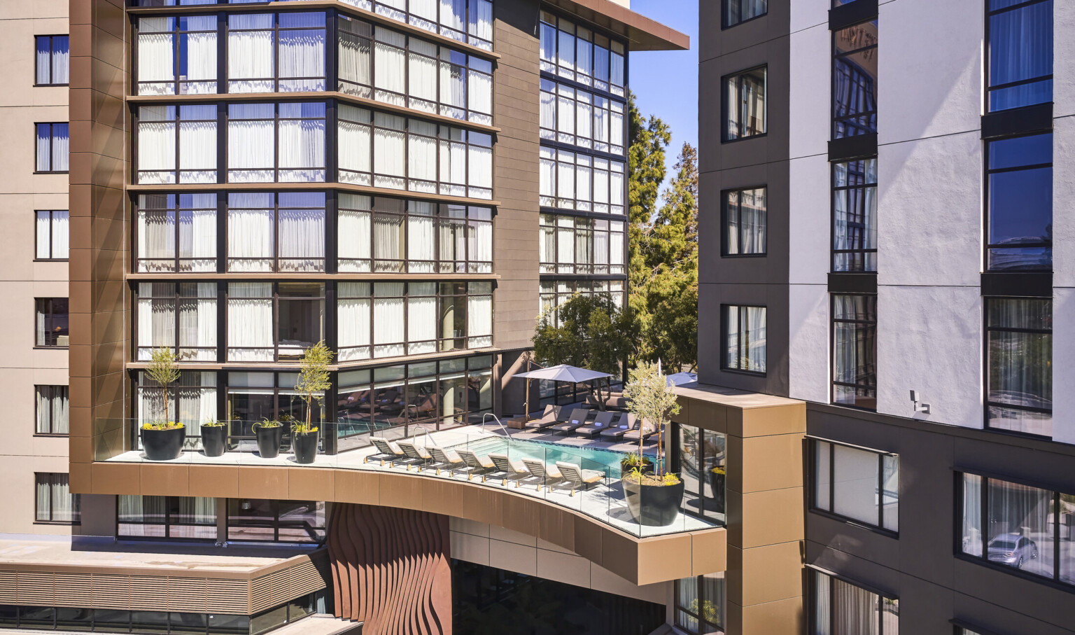 Ariel view of central breezeway featuring a heated outdoor pool on the third floor.