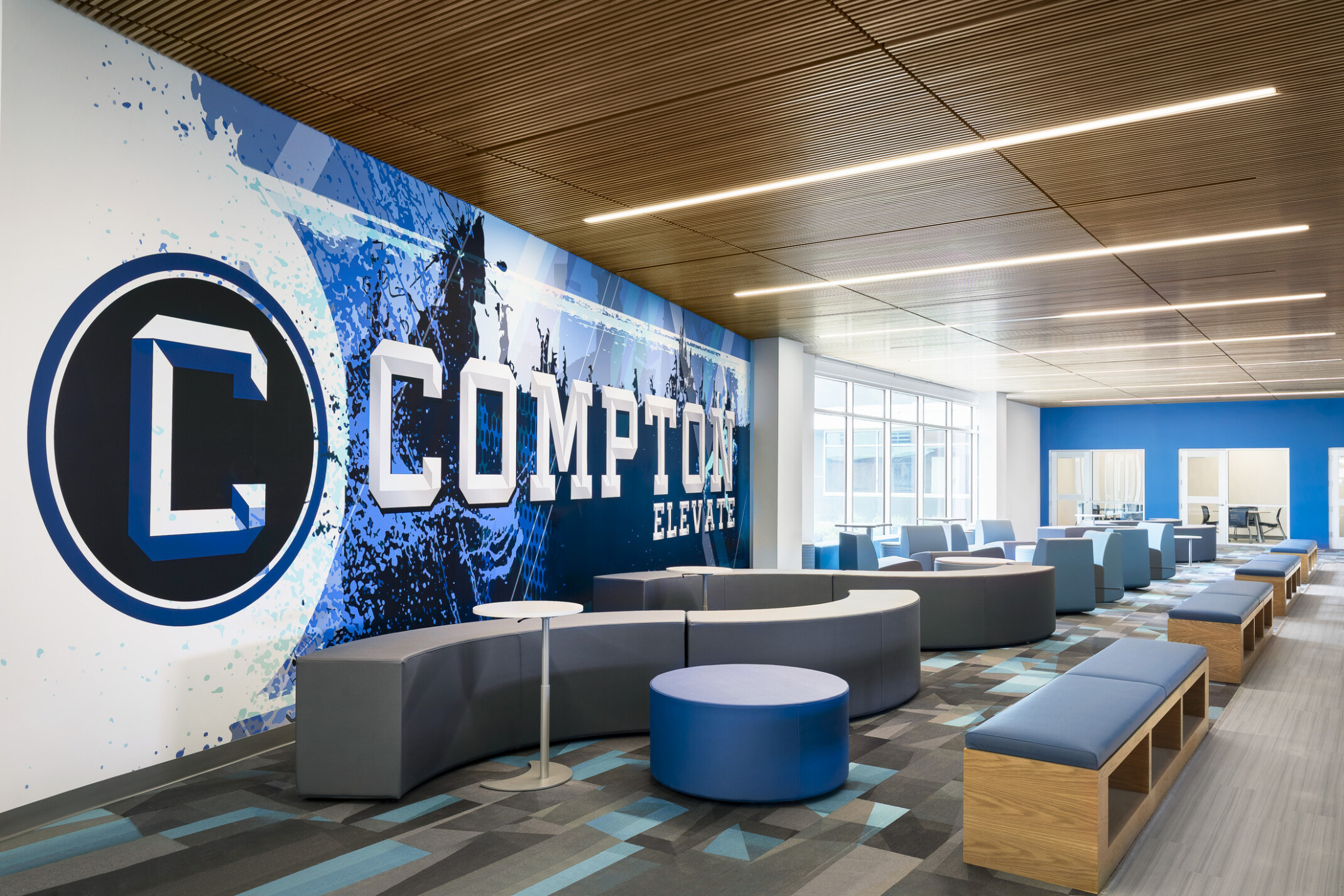 Common area of Compton High School; blue and white graphic design feature wall with "Compton" highlighted
