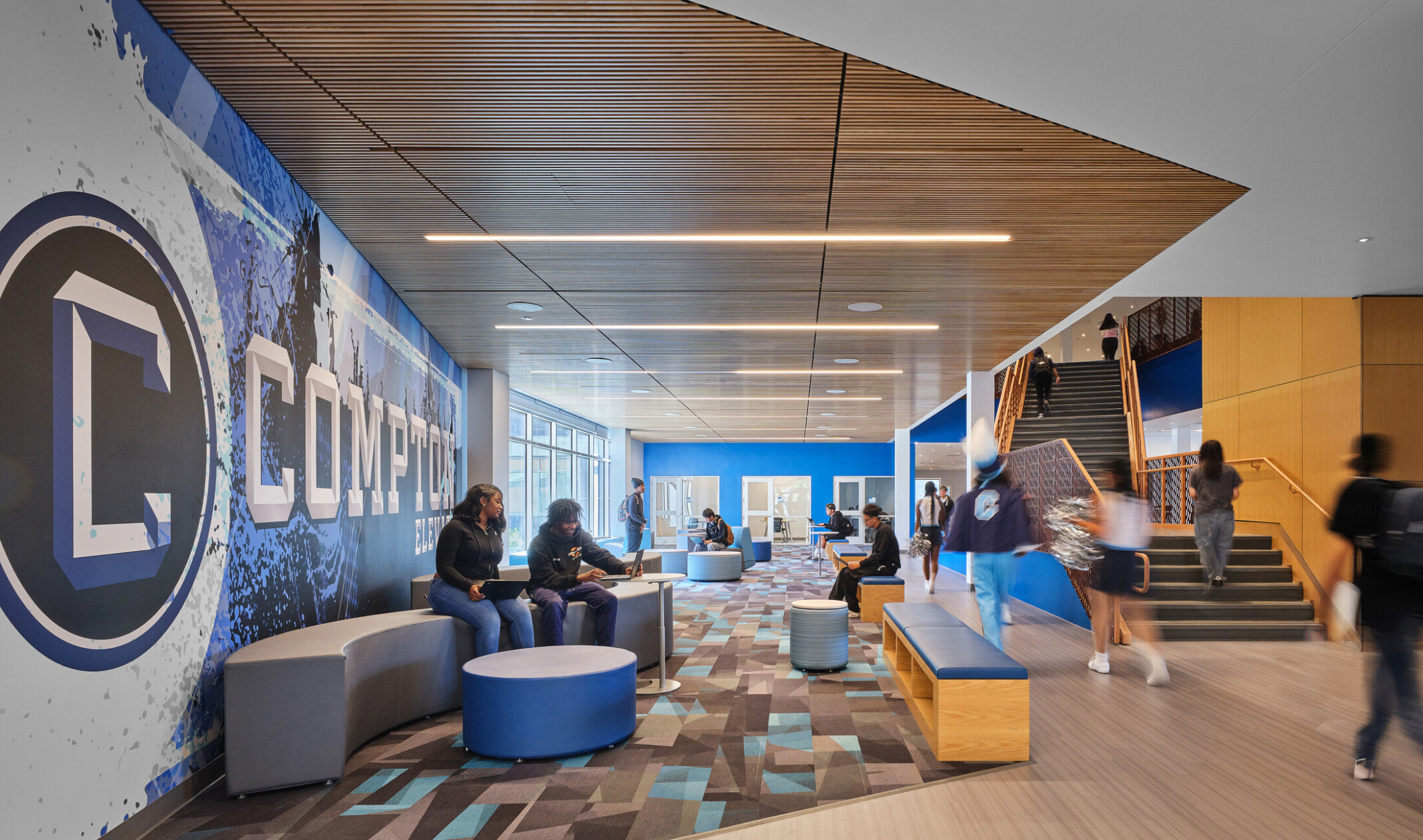 Common area of Compton High School; blue and white graphic design feature wall with 