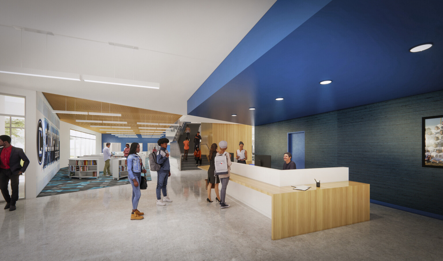 Wood reception desk with white partition sits under a blue drop ceiling accent with recessed lighting. Beyond are bookshelves