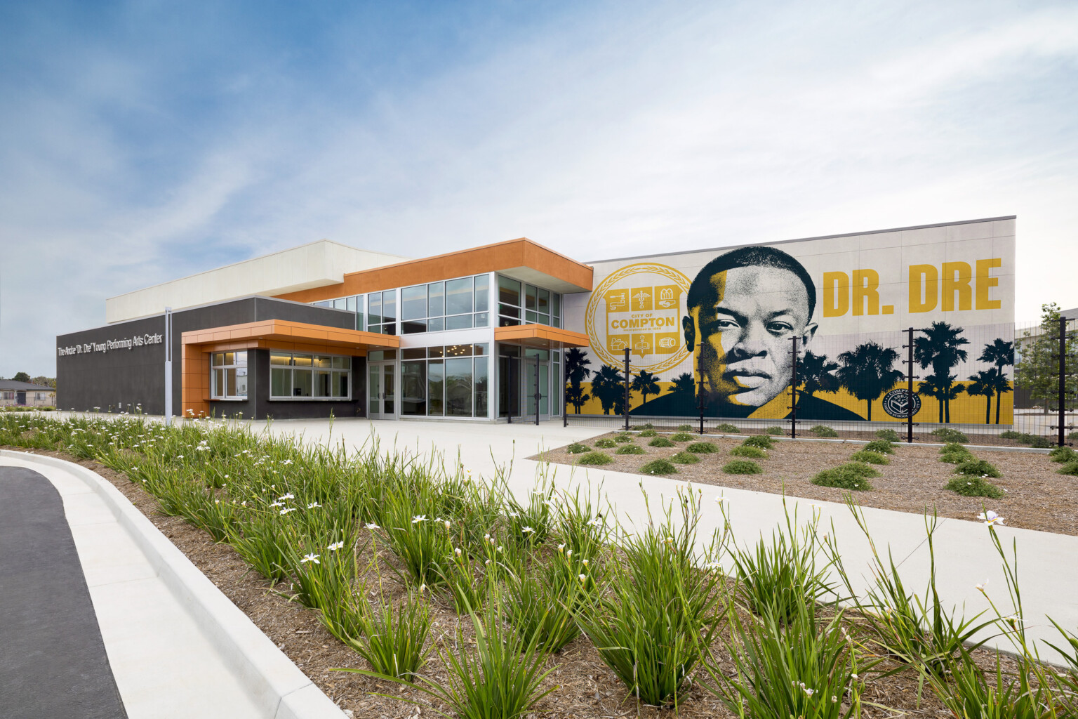 Compton High School Andrew "Dr. Dre" Young Performing Arts Center entrance; modern building with a Dr. Dre mural on the front facing exterior wall
