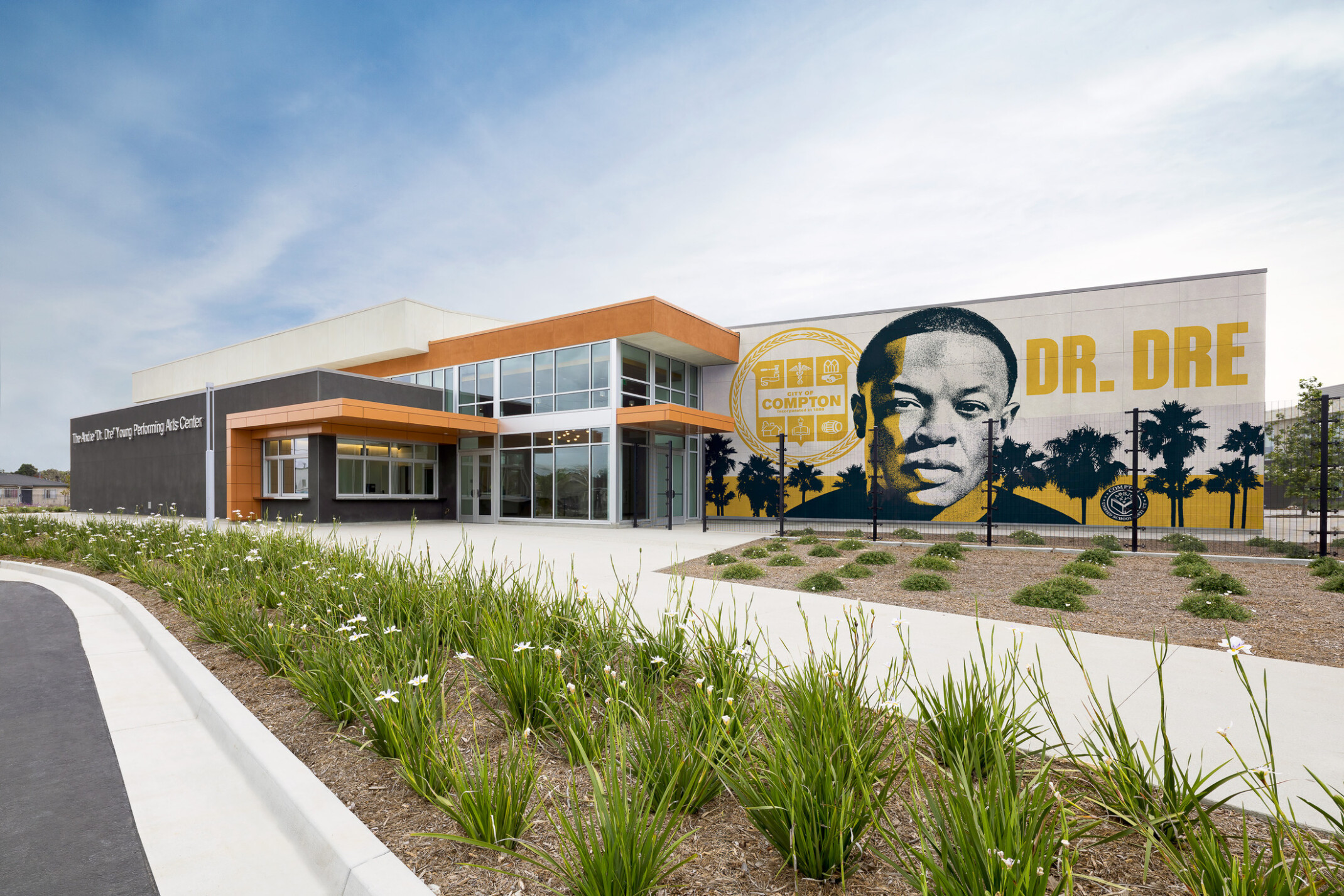 Compton High School Andrew "Dr. Dre" Young Performing Arts Center entrance; modern building with a Dr. Dre mural on the front facing exterior wall
