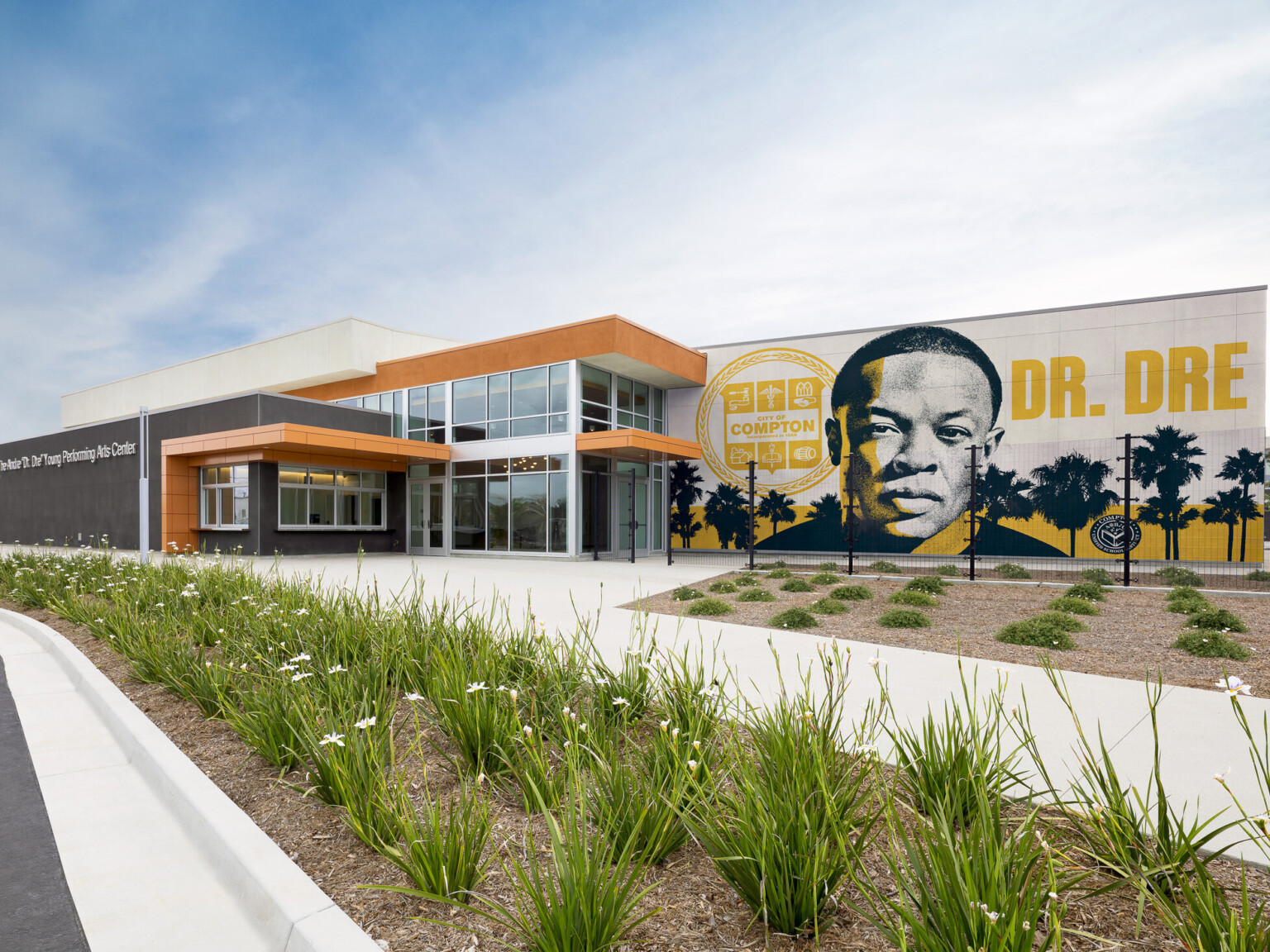 Compton High School Andrew "Dr. Dre" Young Performing Arts Center entrance; modern building with a Dr. Dre mural on the front facing exterior wall