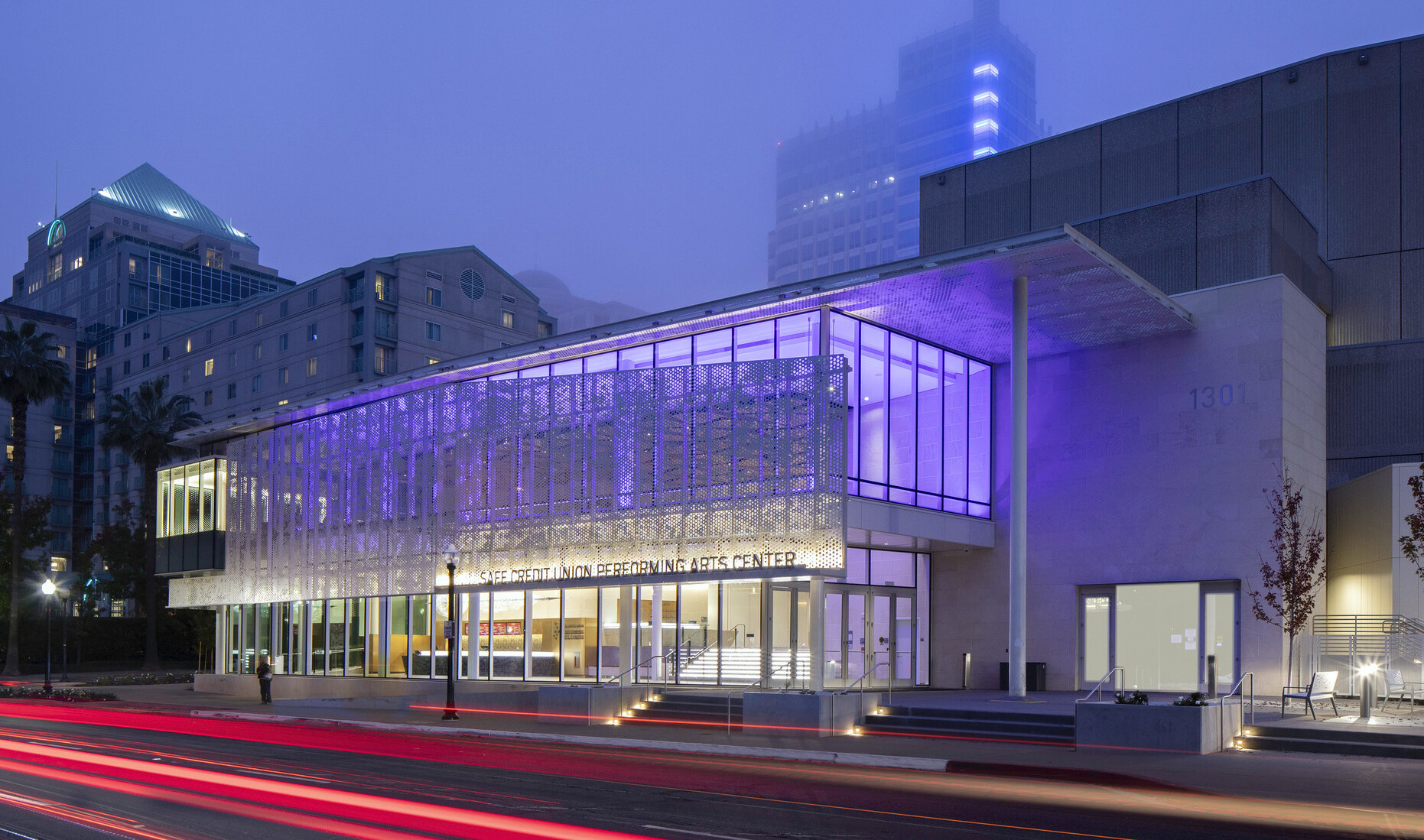 SAFE Credit Union Performing Arts Center in Sacramento viewed from across the street , lit from within by purple lights