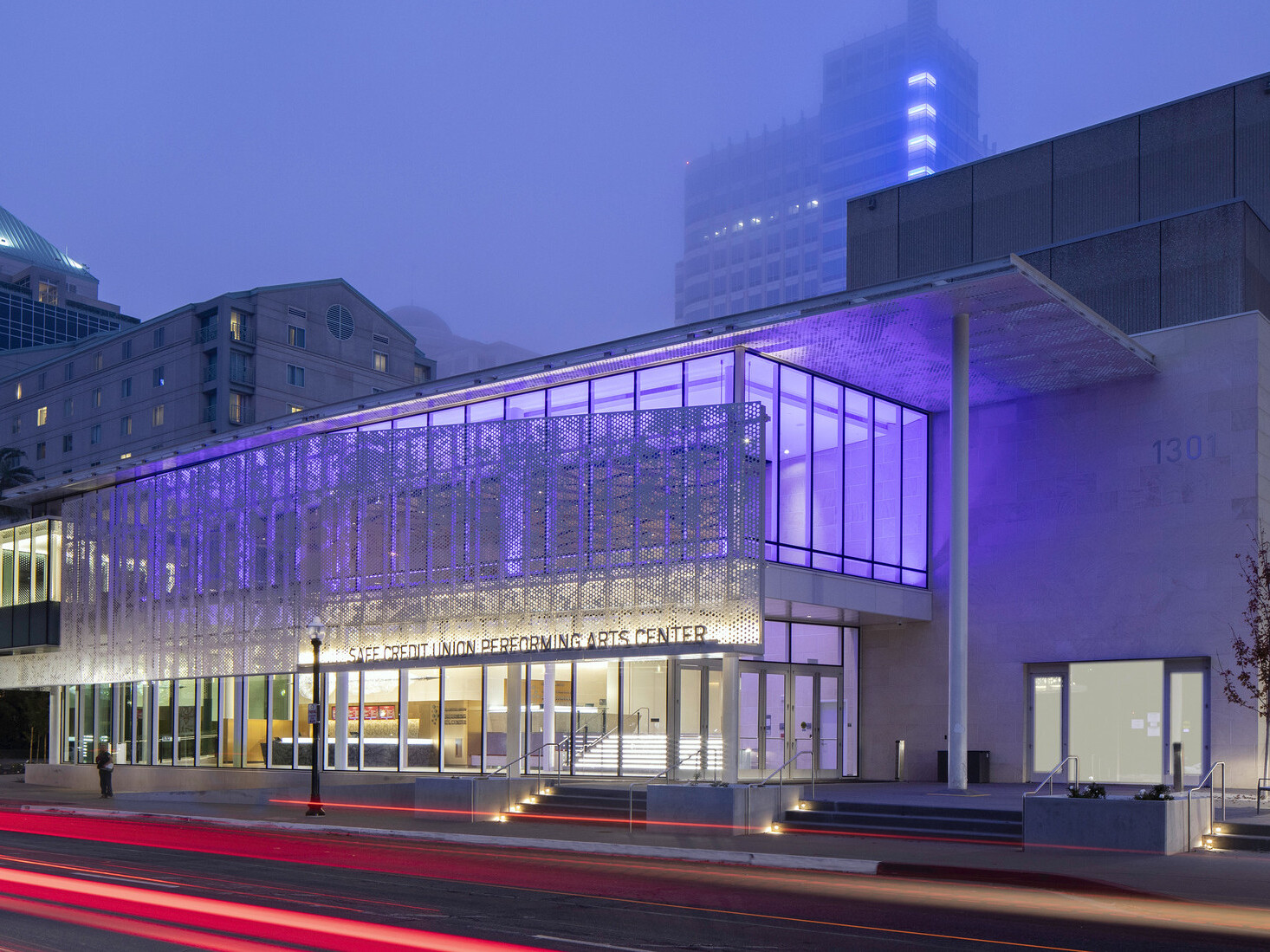 SAFE Credit Union Performing Arts Center in Sacramento viewed from across the street , lit from within by purple lights
