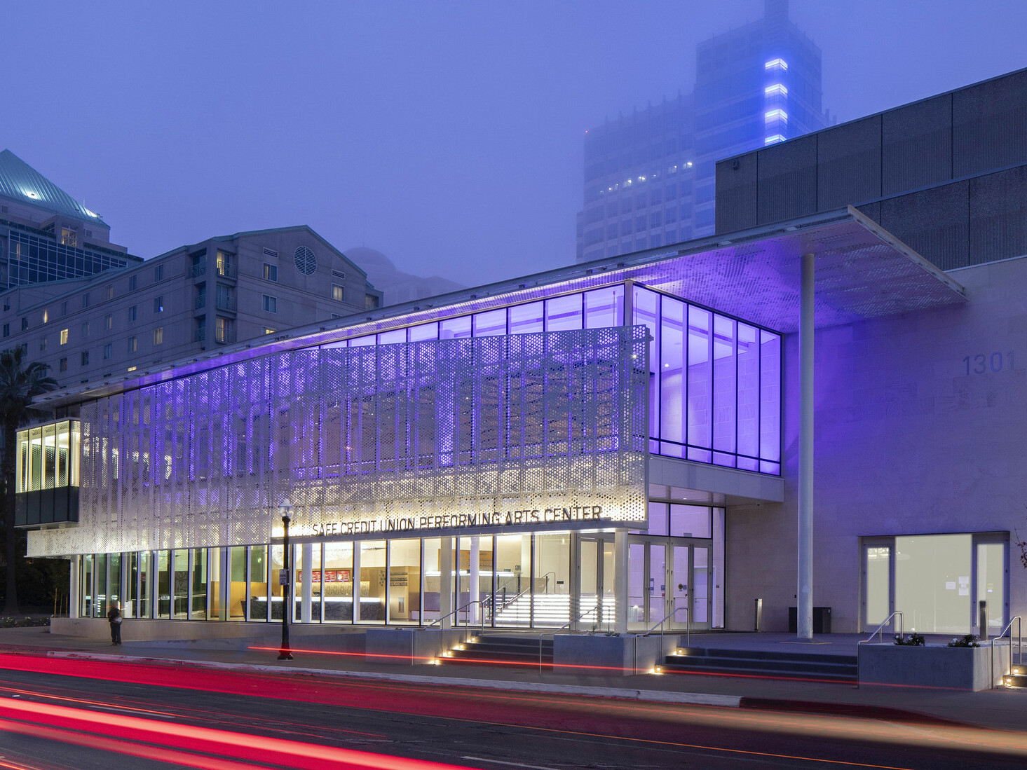 SAFE Credit Union Performing Arts Center in Sacramento viewed from across the street, lit from within by purple lights