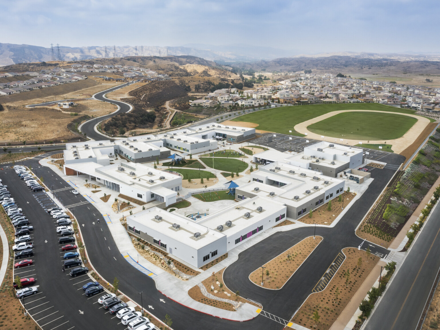 aerial view of campus with green grass snaking through