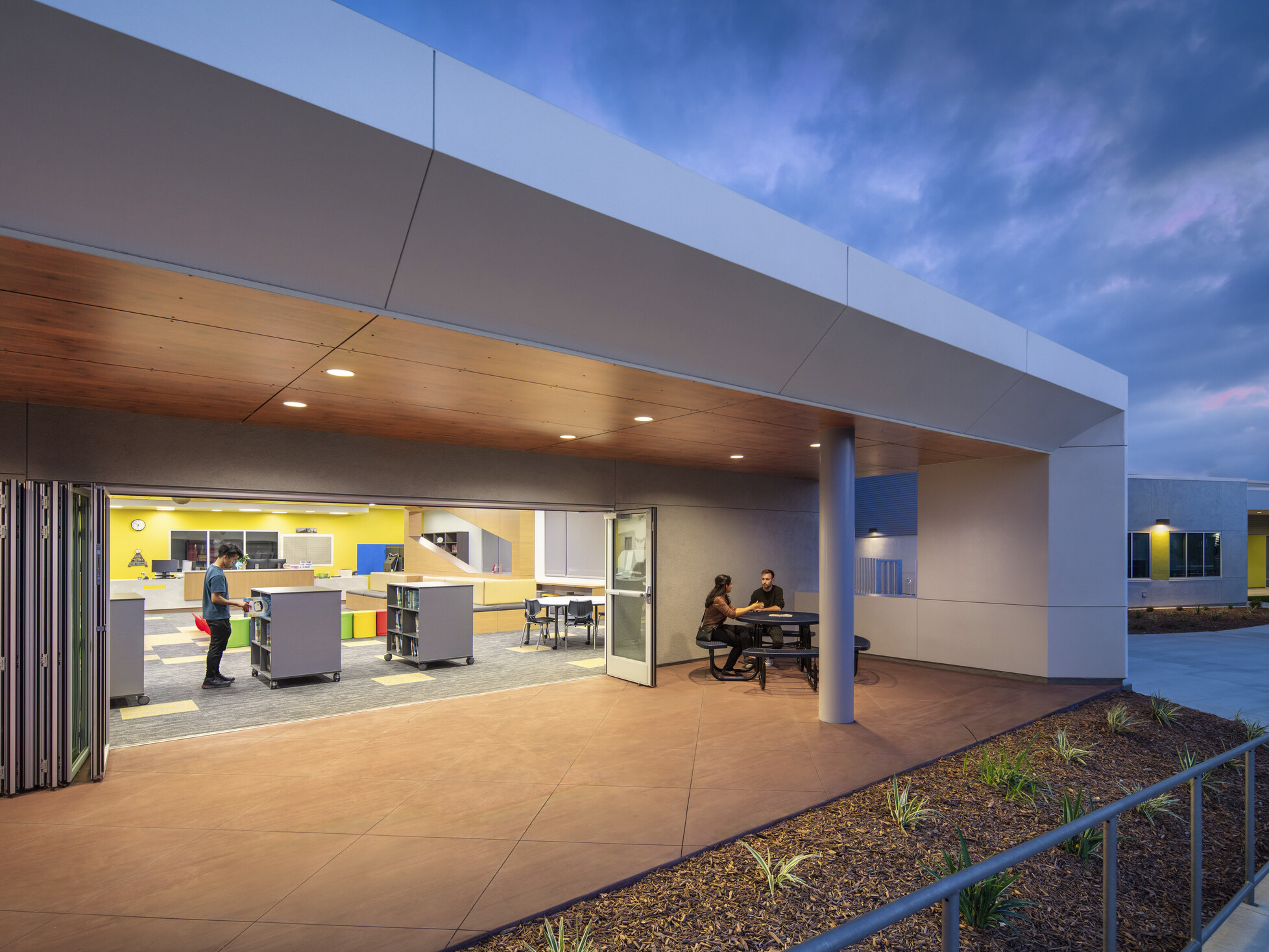 Exterior of Beaumont USD Summerwind K-8 School white wrapped facade canopies with brown base