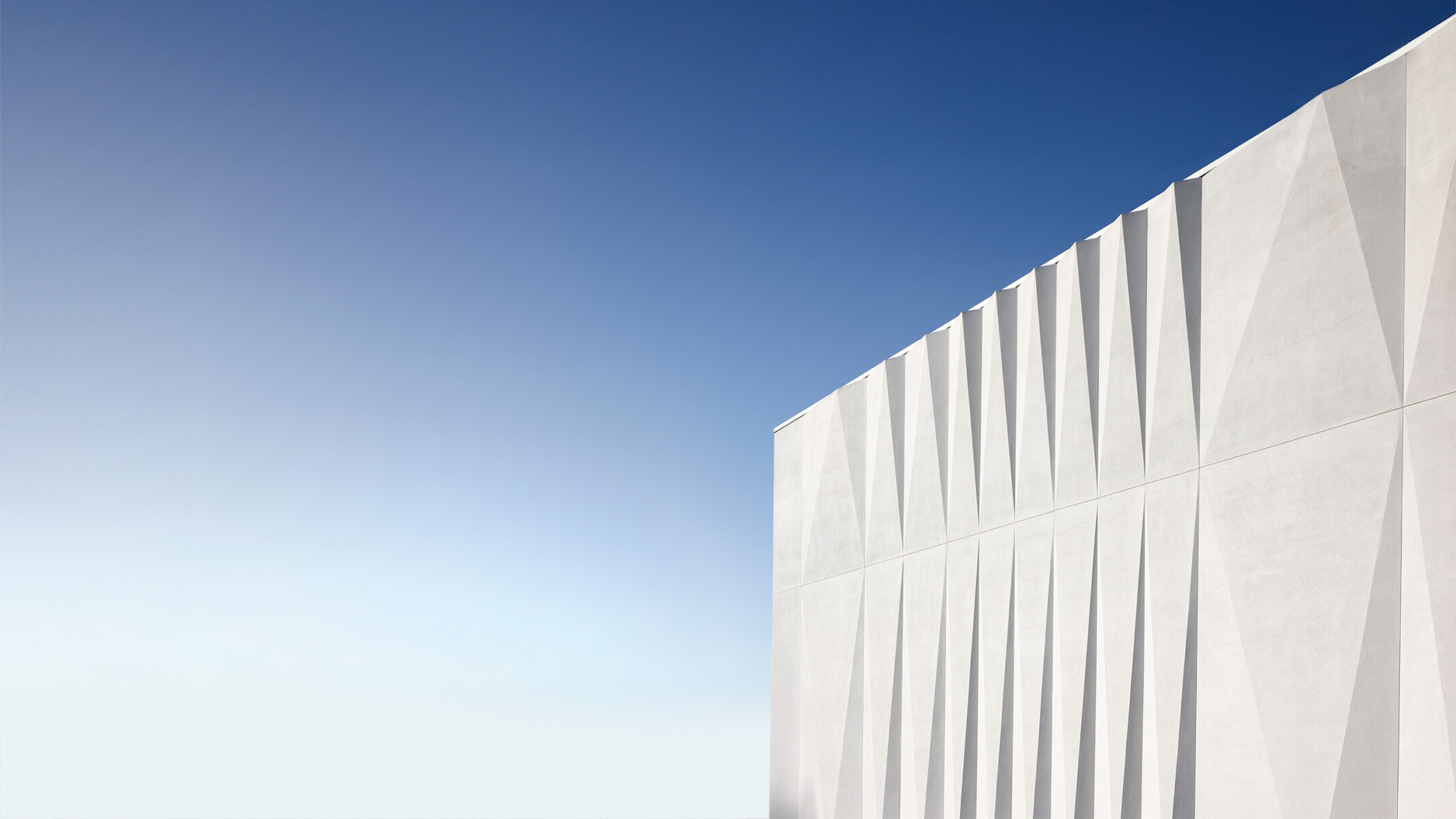white angular facade against a blue sky