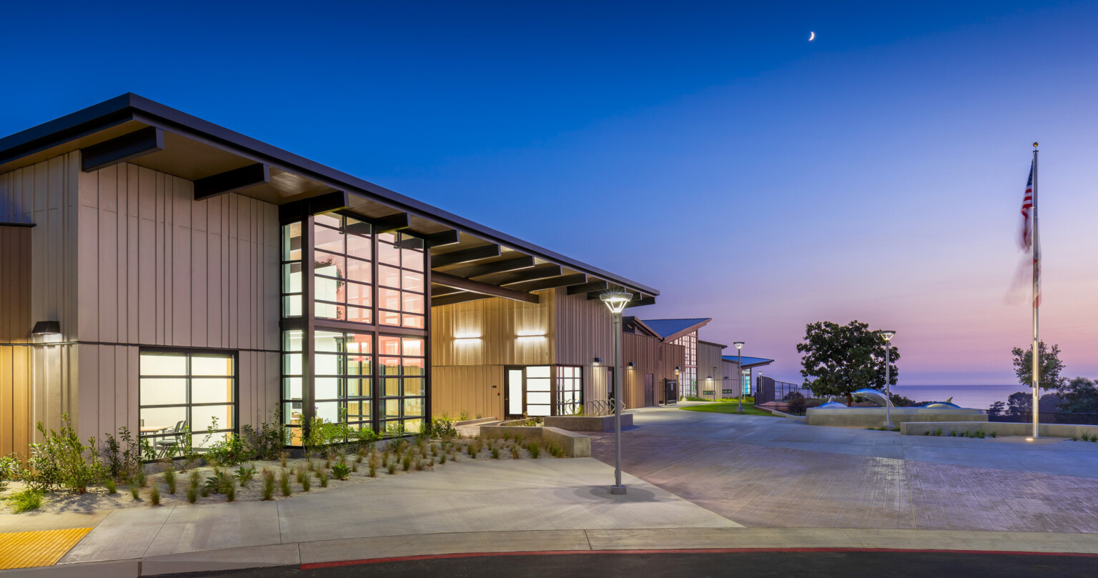 exterior of k-12 school at night, architecture inspired by California Coastal Architecture, expansive views