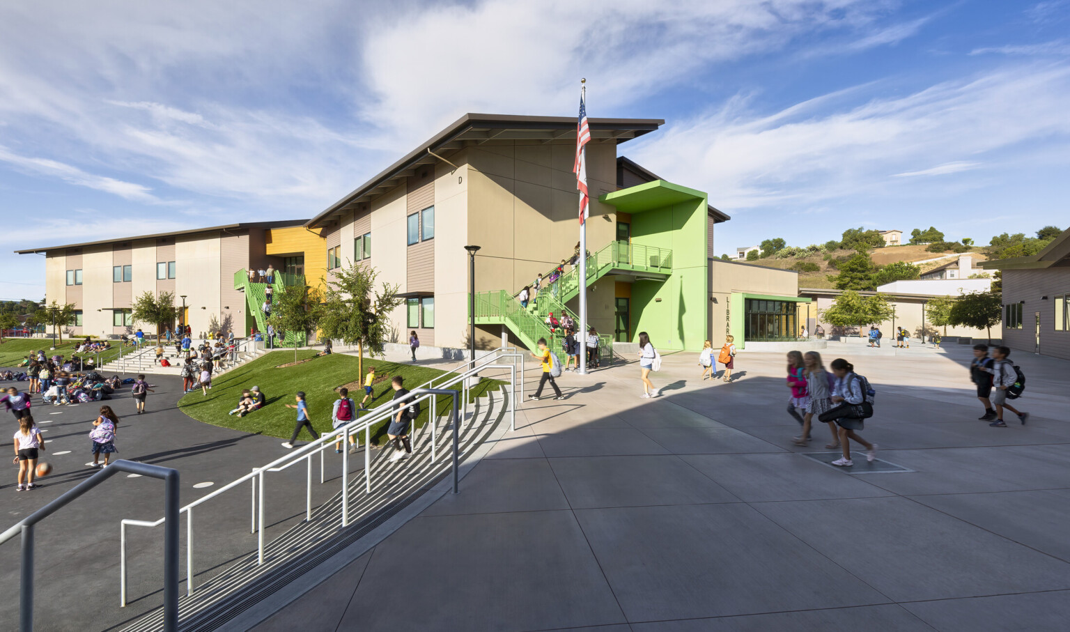 Richland Elementary School exterior partially shaded courtyard with steps to playground; campus design with multistory buildings