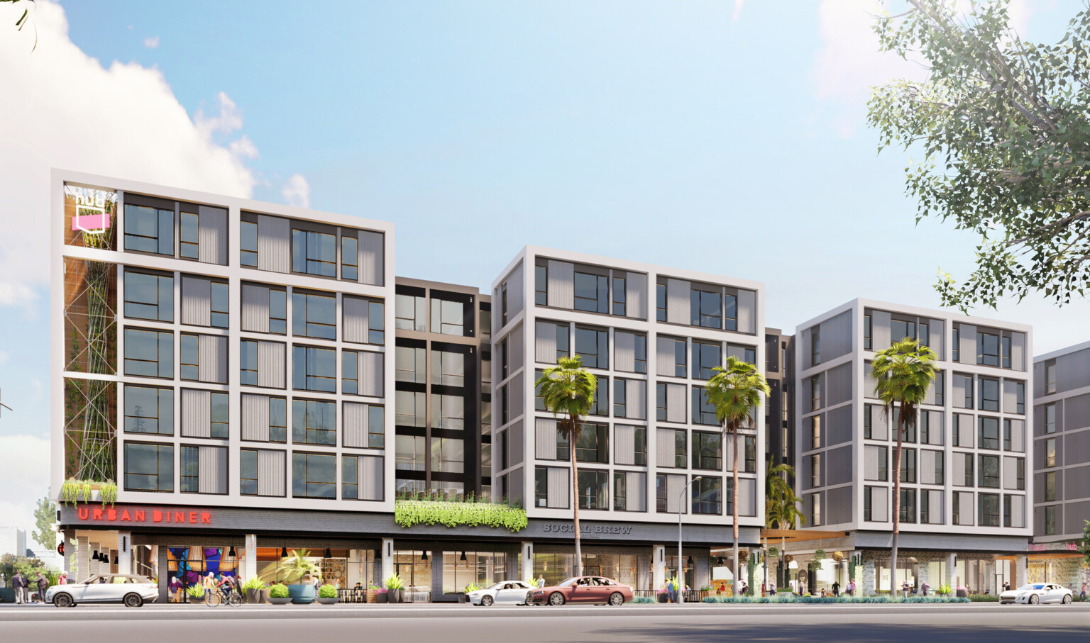 Exterior of multistory building with HUB sign on left corner and green space along second floor wall, dining space on 1st floor