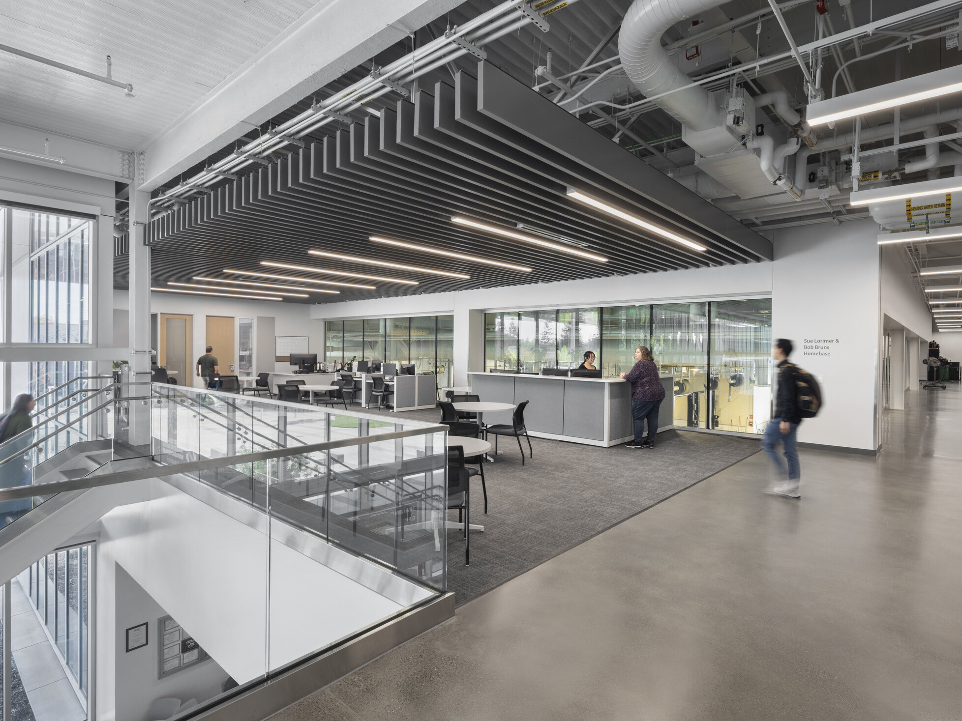 large open technical education space with exposed architectural elements and modular workspaces