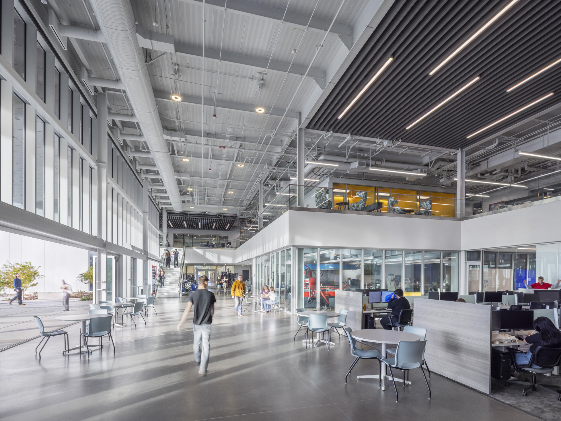 large open technical education space with exposed architectural elements and modular workspaces