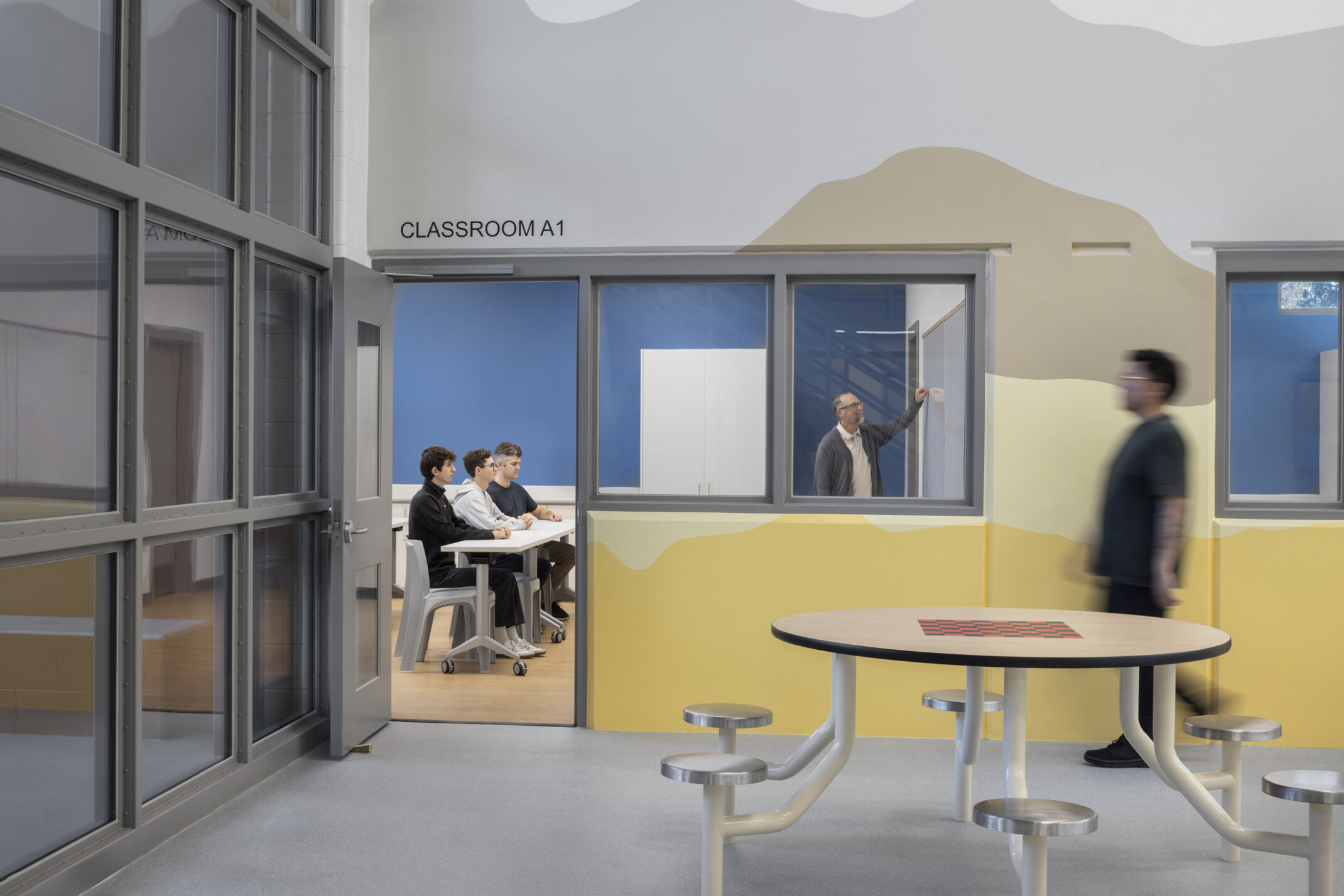 Entrance to the Housing Dayroom Programs Classroom with a muted mountain mural on the entrance wall.