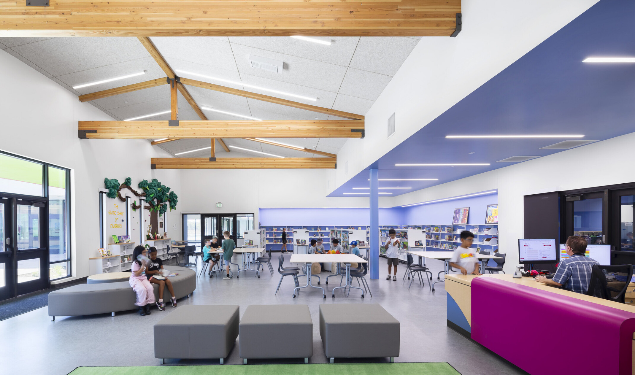 architectural rendering of Central area for students to gather and read; colorful modular furniture throughout