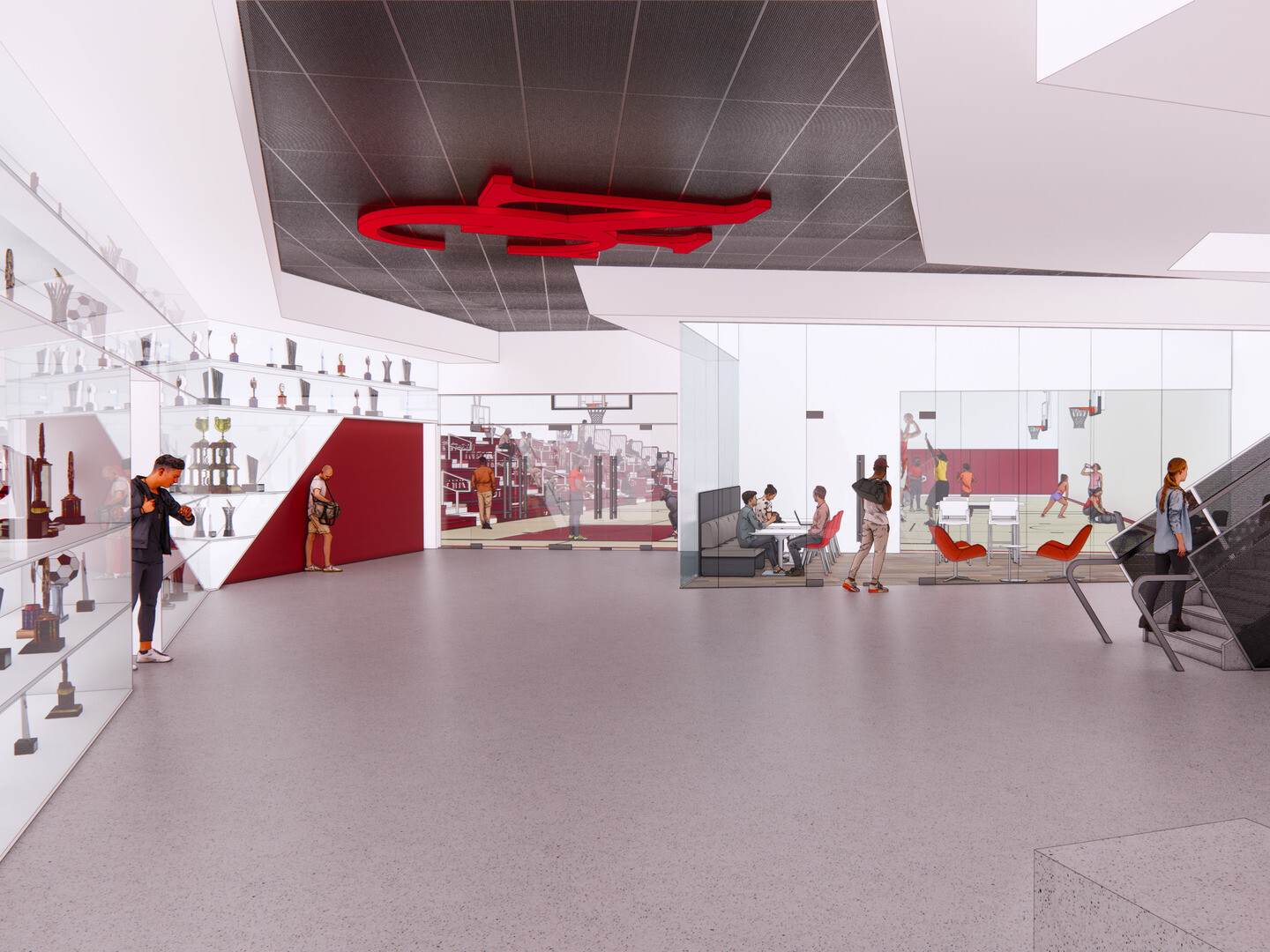 Contemporary athletic facility lobby featuring trophy displays, informal seating, meeting spaces, and a prominent staircase connecting multiple levels