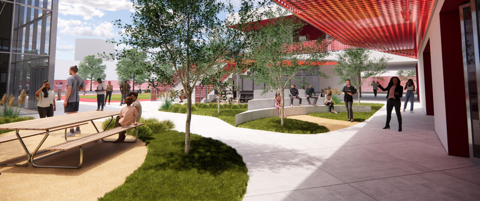 Outdoor courtyard with modern red awnings filled with people and lush landscaping