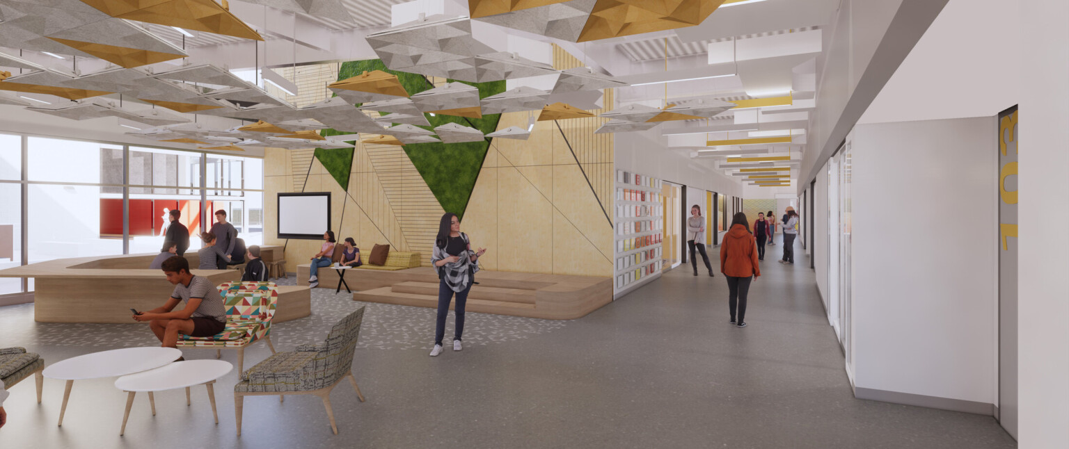 School common area showing modern wood furnishings, colorful chairs, and students collaborating