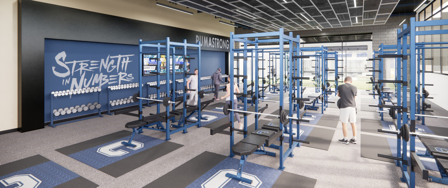 High school weight room with blue weight equipment surrounded by large windows and a blue accent wall