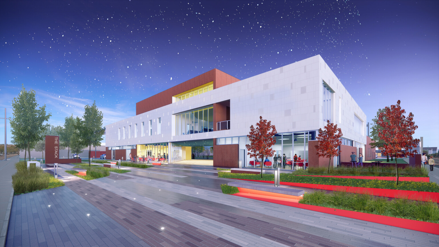 The Stack sits against a twilight sky, surrounded by manicured landscaping, people mingling throughout, and neatly paved walkways.