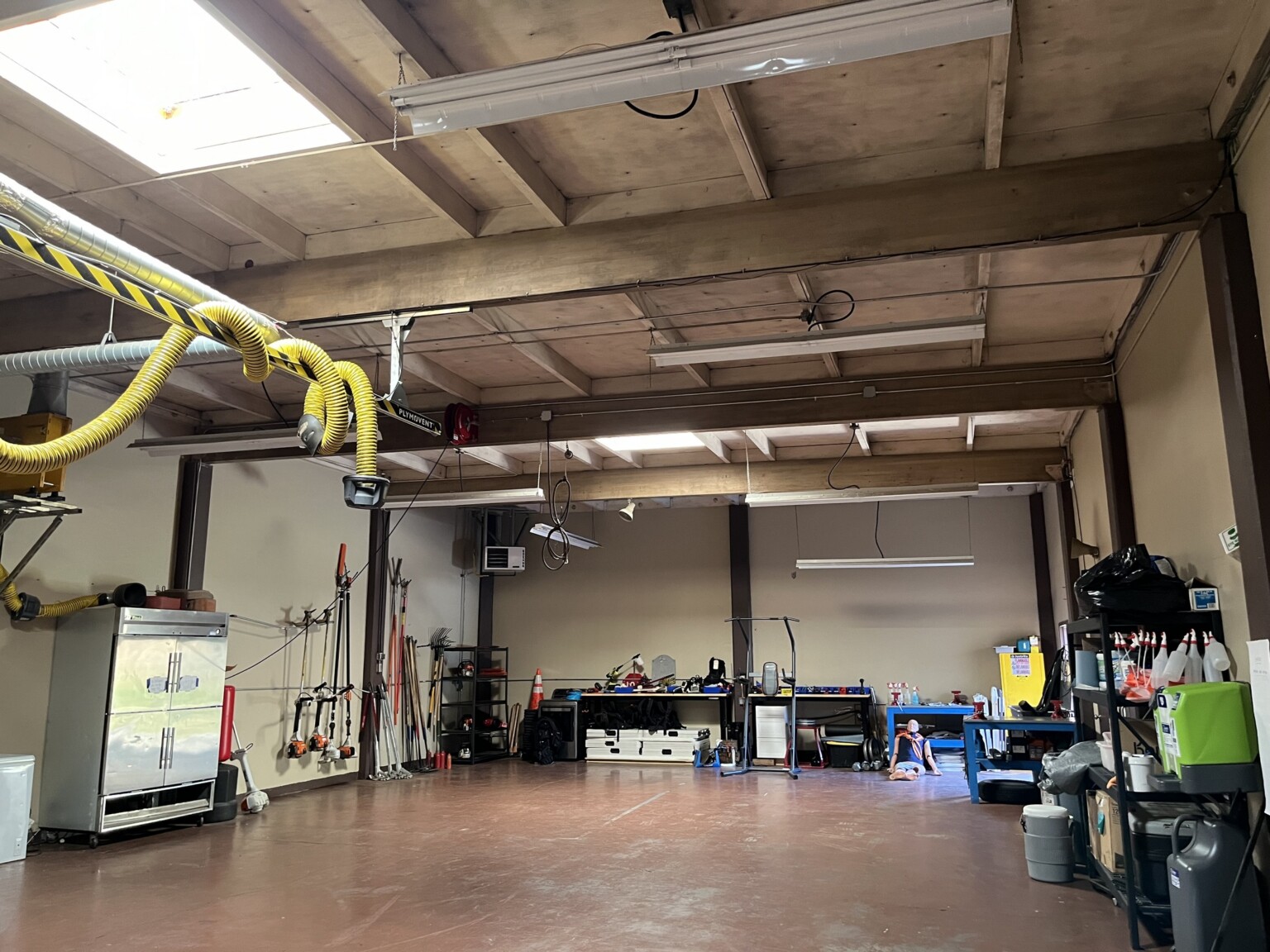 Fire station warehouse area with exposed ceiling and structural elements