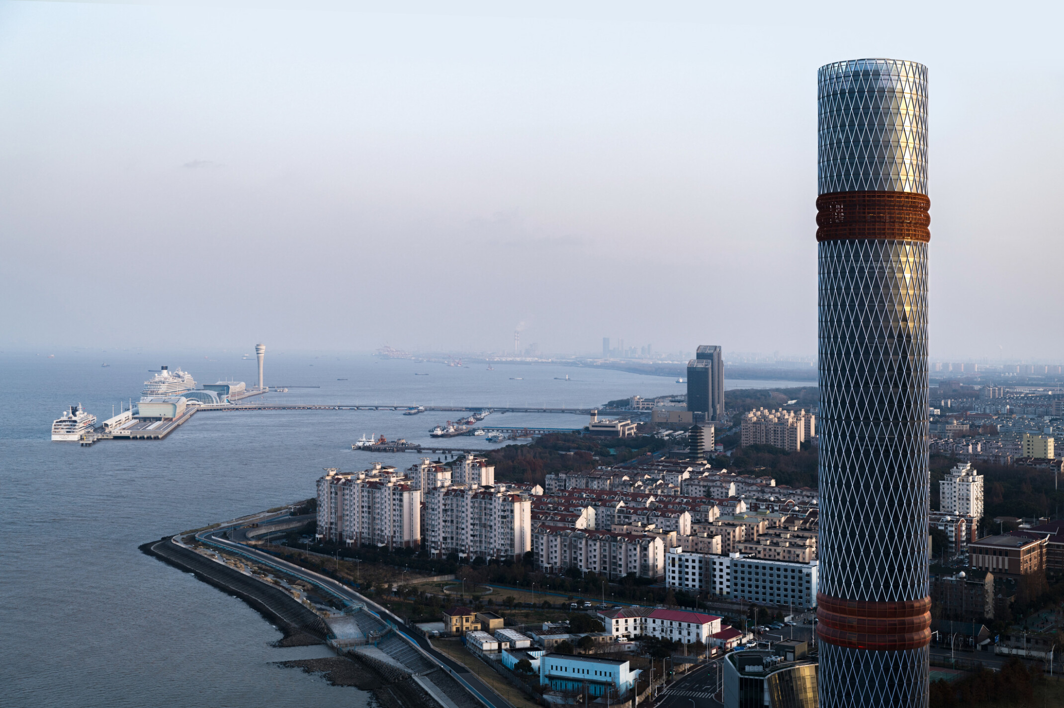 Baoshan Long Beach Complex along Shanghai's Yangtze River, cylindrical tower with two red facade bands