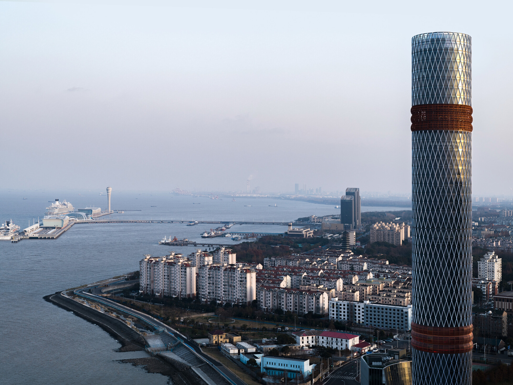Baoshan Long Beach Complex along Shanghai's Yangtze River, cylindrical tower with two red facade bands
