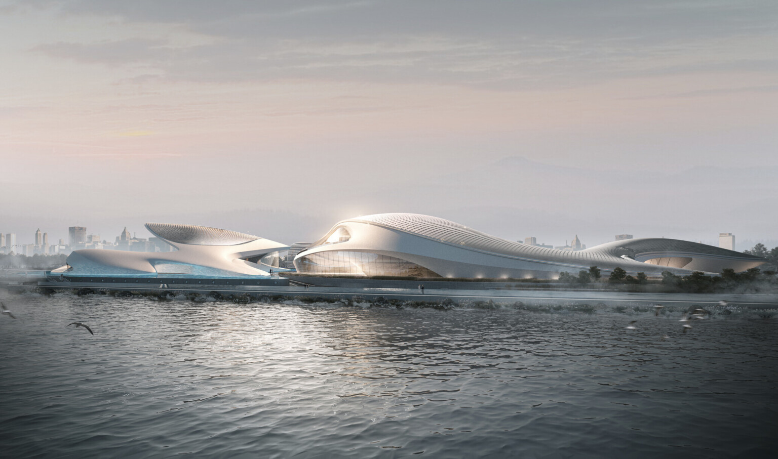 White organically rounded building along waterfront with canopied seating area. Double height windows sporadically
