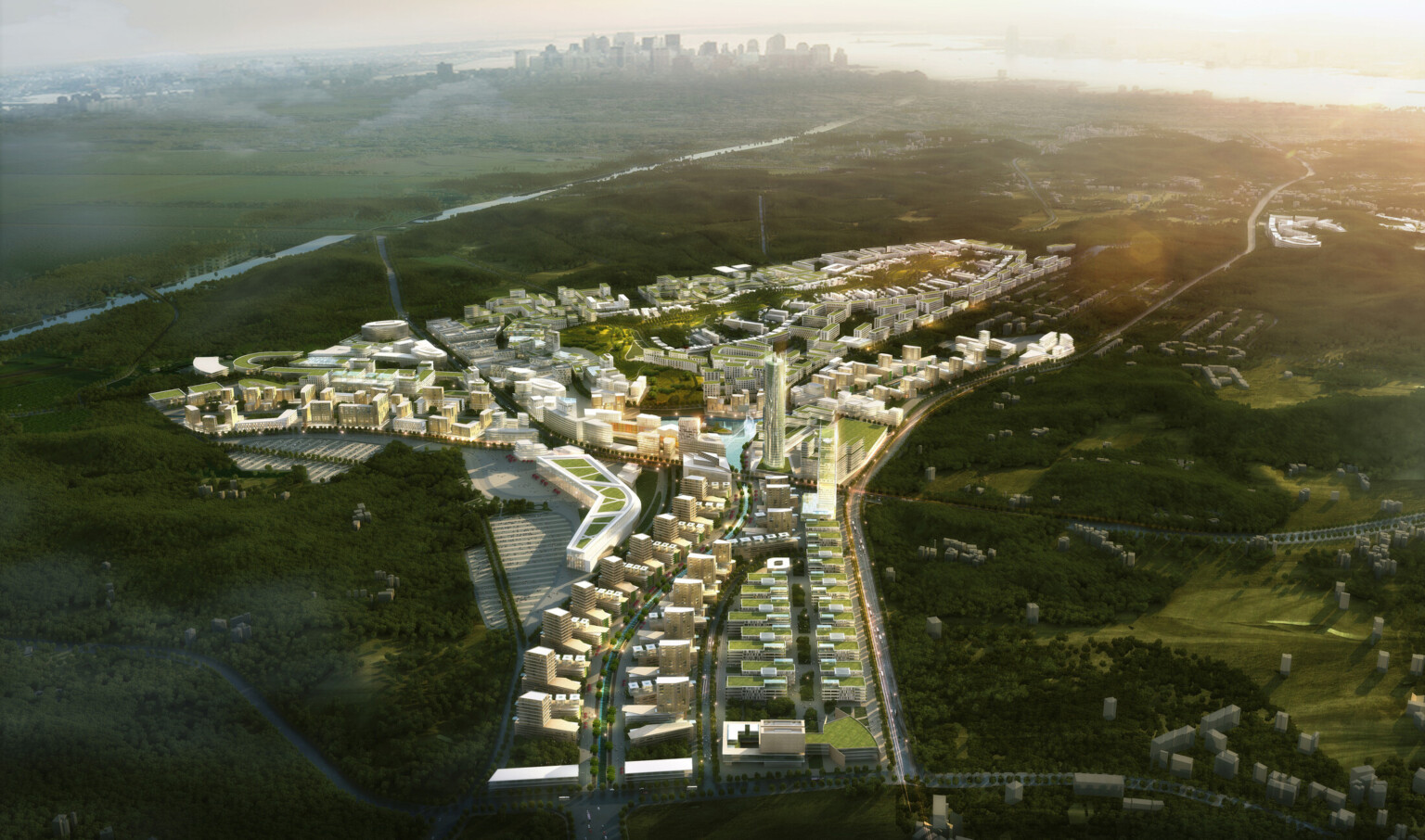 Aerial view of city with green roof multistory buildings and tall cylindrical tower surrounded by green hills