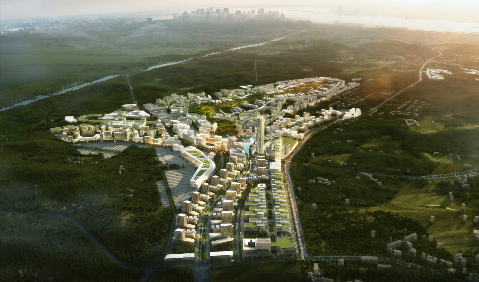 Aerial view of city with green roof multistory buildings and tall cylindrical tower surrounded by green hills