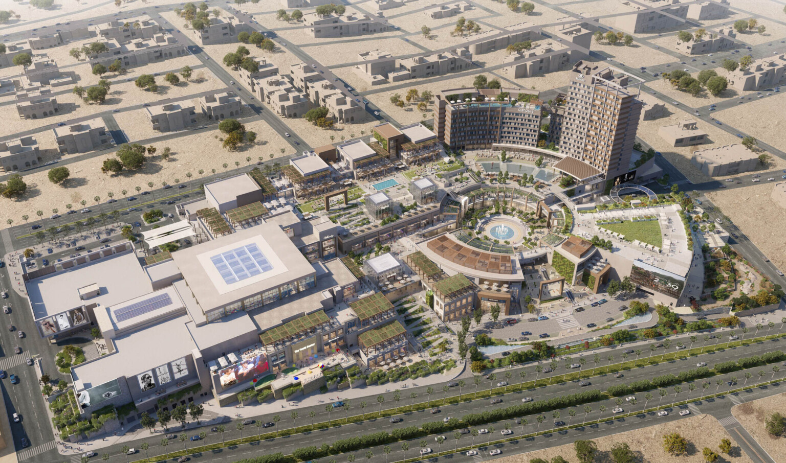 Aerial view of the campus plan built into a hill with rounded central courtyard lined with canopies, midrise buildings to left