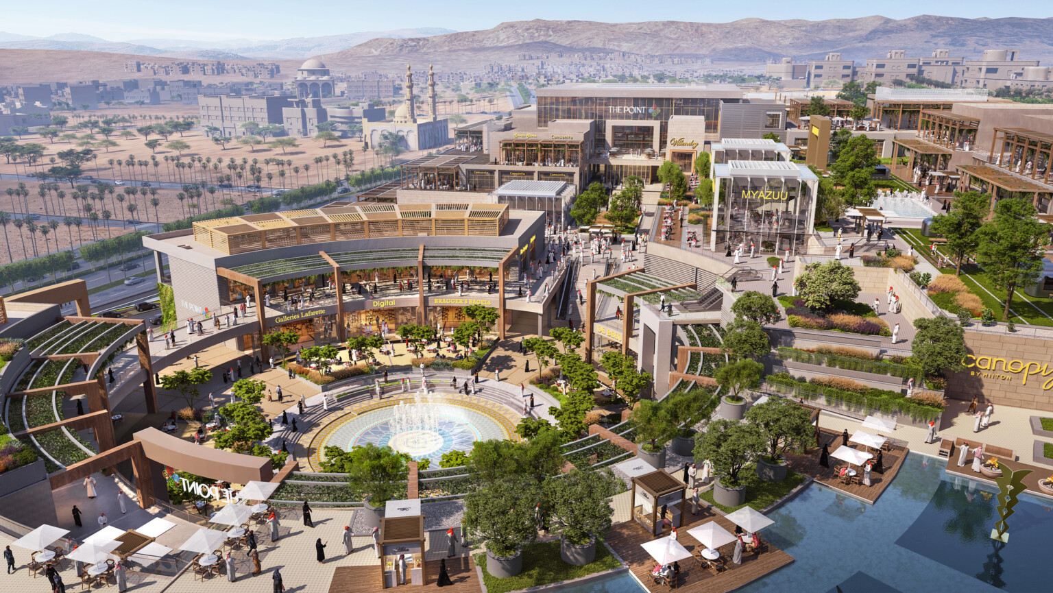 Aerial view of the campus plan built into a hill with rounded central courtyard lined with canopies, midrise buildings to left