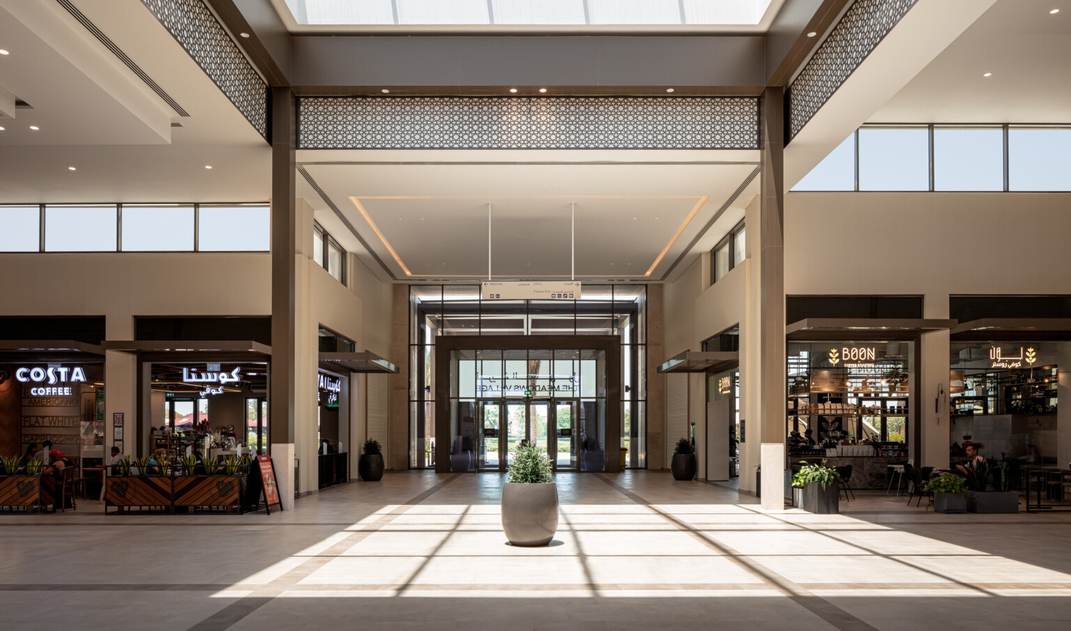Interior of a shopping mall with a ceiling of windows with lots of natural light