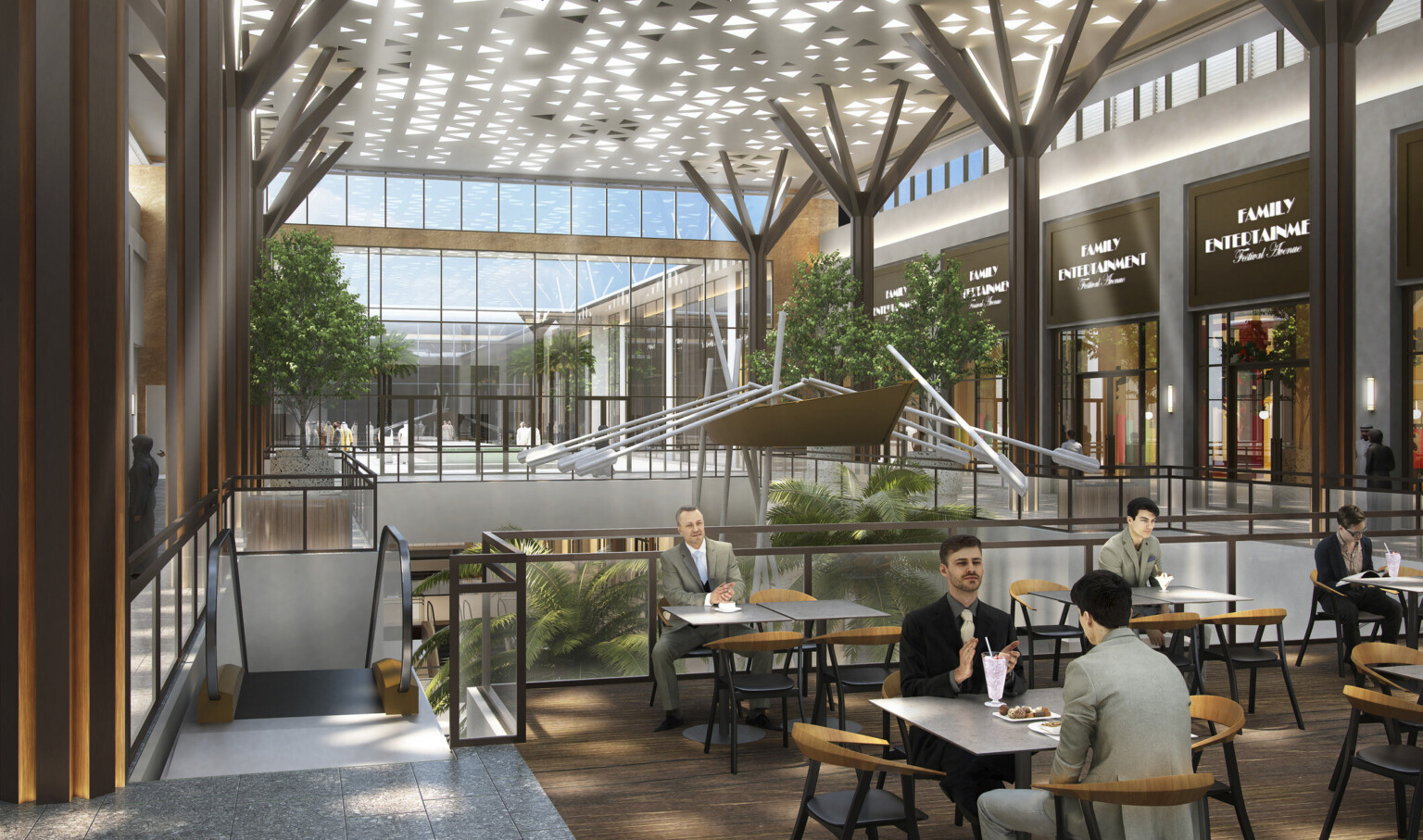 Seating area in atrium upper level. Shops along sides with double height glass wall, back. Panel with triangle cutouts above