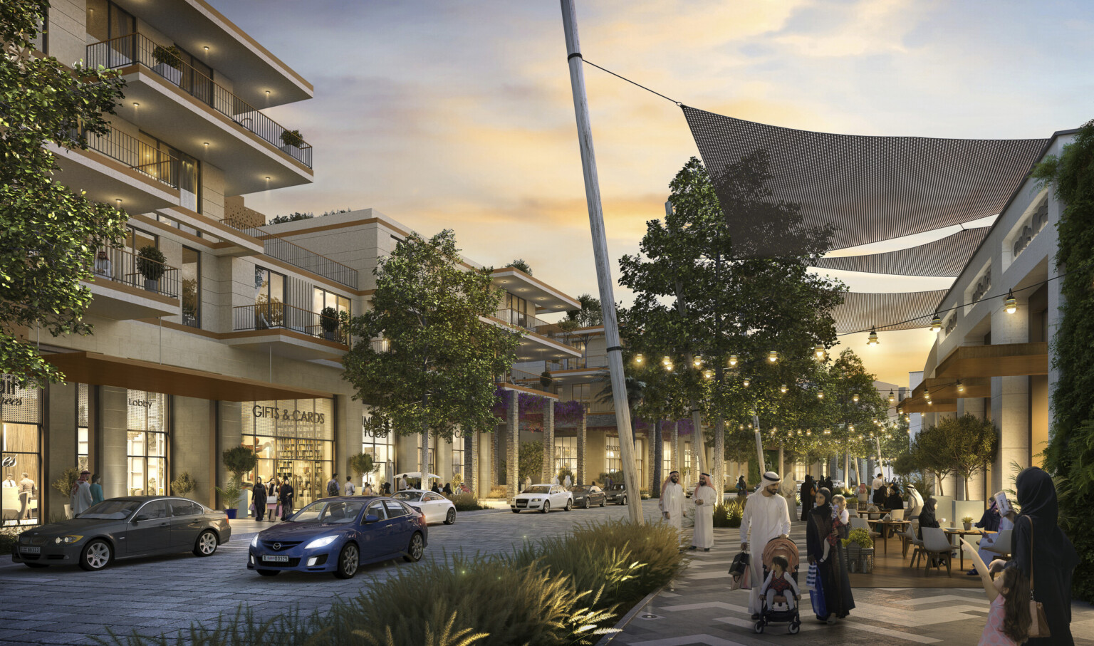Multistory light color buildings with brown accents line curved road. Right, sunscreens drape from building with string light Multistory light color buildings with brown accents line curved road. Right, sunscreens drape from building with string light