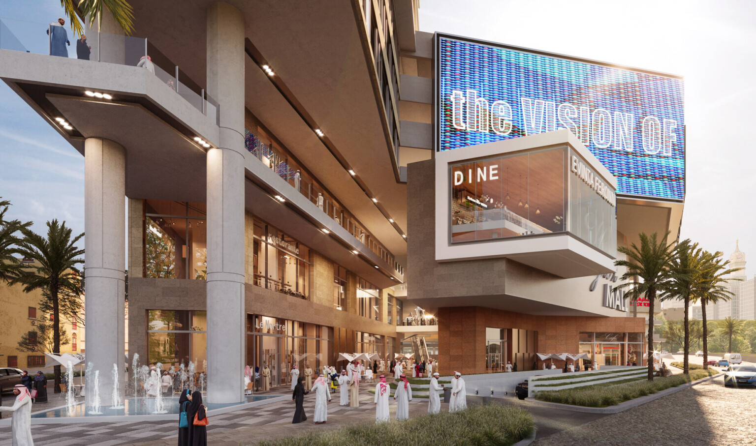 Partially covered walkway in multistory shopping center with overhanging 4th floor over glass balcony. Ground level fountain