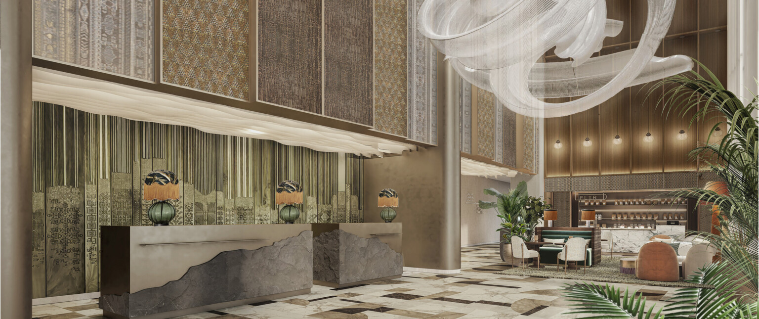 A beautifully designed hotel lobby with elegant furnishings and a welcoming atmosphere. A centerpiece light fixture cascading down from the ceiling, green live plants decorate the lobby.