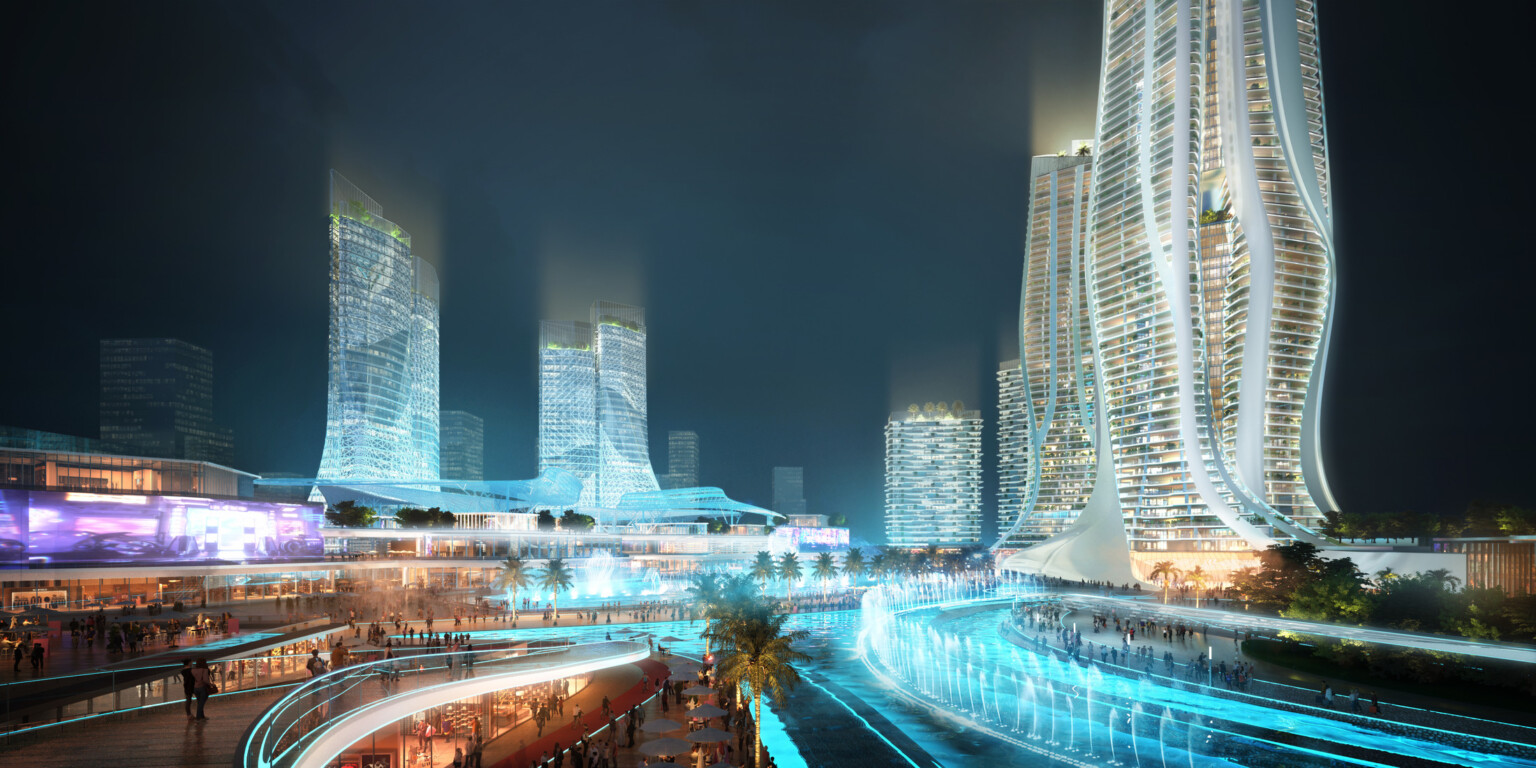 A vibrant nighttime view of The Heart of the master plan, featuring a collection of futuristic high-rise buildings with unique, flowing designs.
