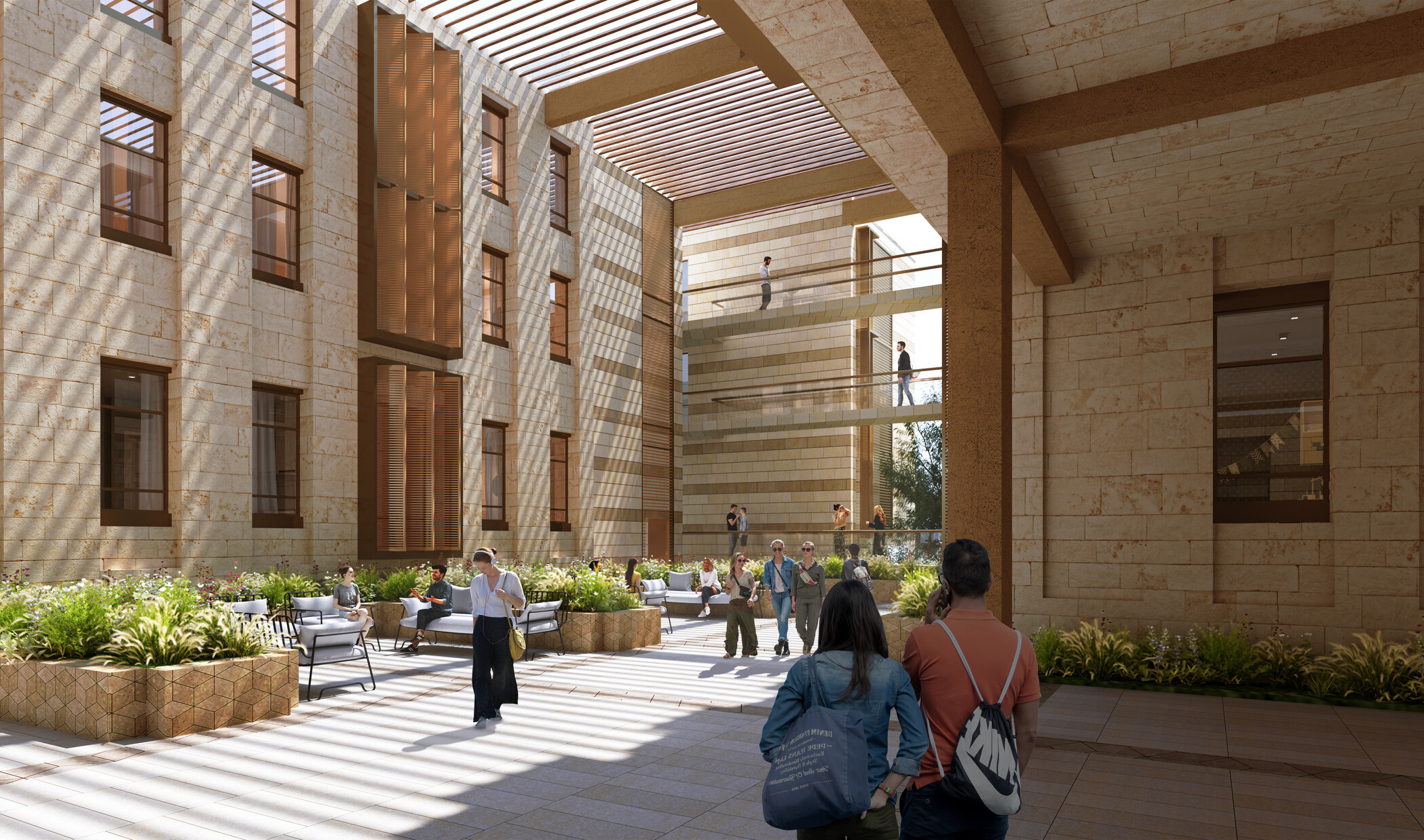An interior courtyard of a university building. The space is open to the sky and features a mix of stone and wooden architectural elements, with sunlight streaming through slatted overhead structures, creating intricate patterns of light and shadow on the ground